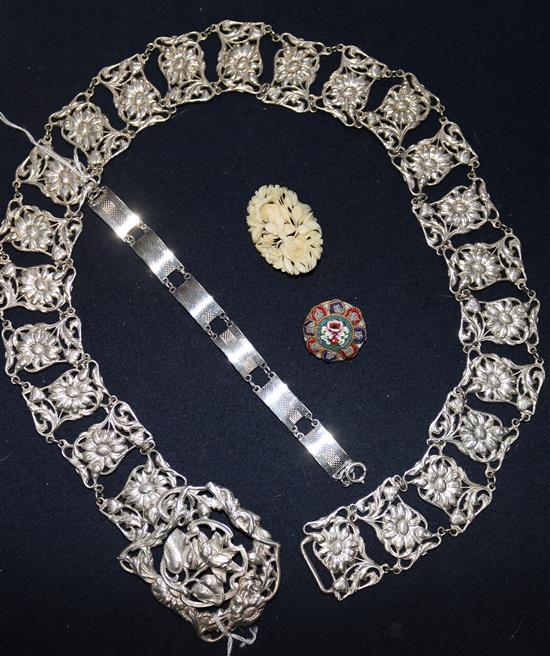 A silver plated ladys belt, a silver bracelet and two brooches